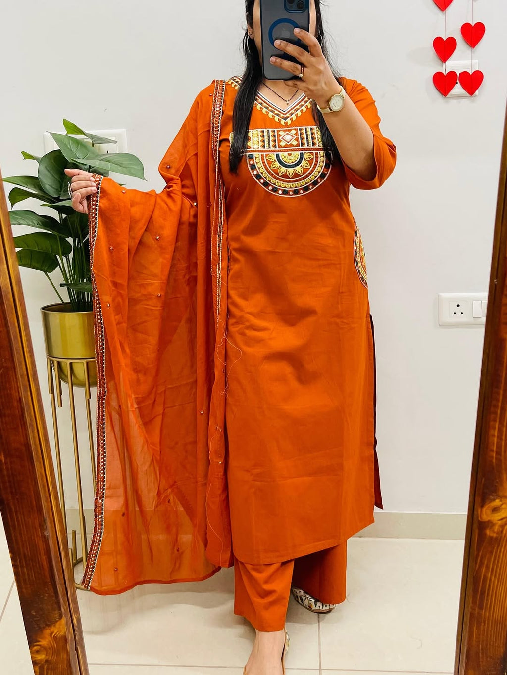 Rust-colored cotton kurta, pant, and dupatta set with embroidery work