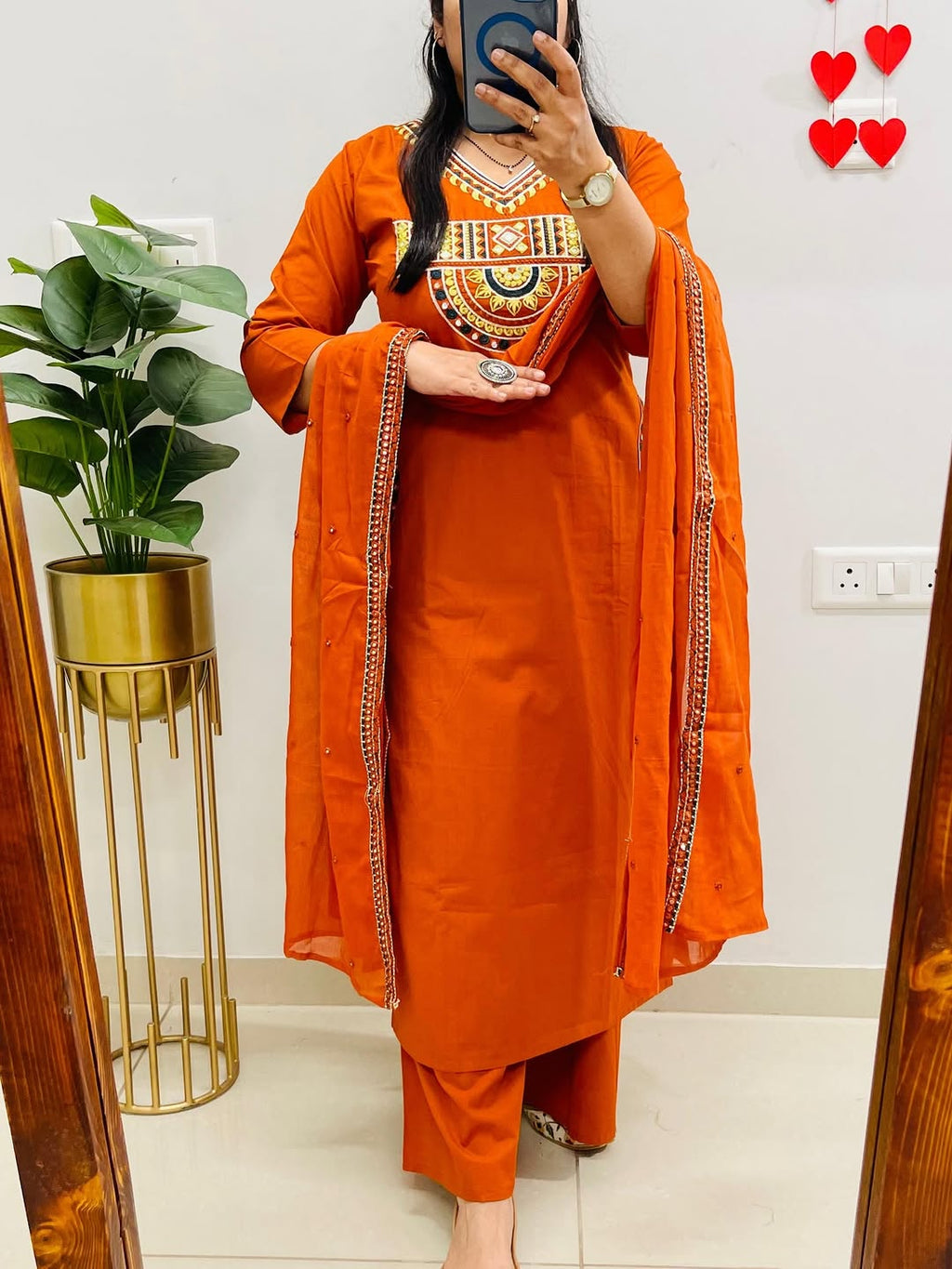 Rust-colored cotton kurta, pant, and dupatta set with embroidery work