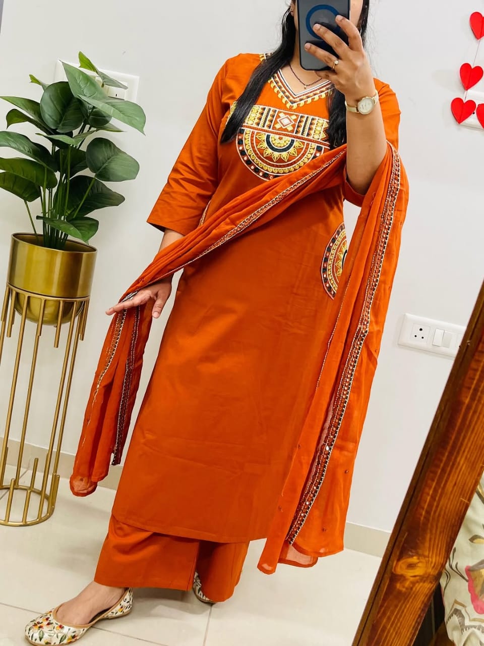 Rust-colored cotton kurta, pant, and dupatta set with embroidery work