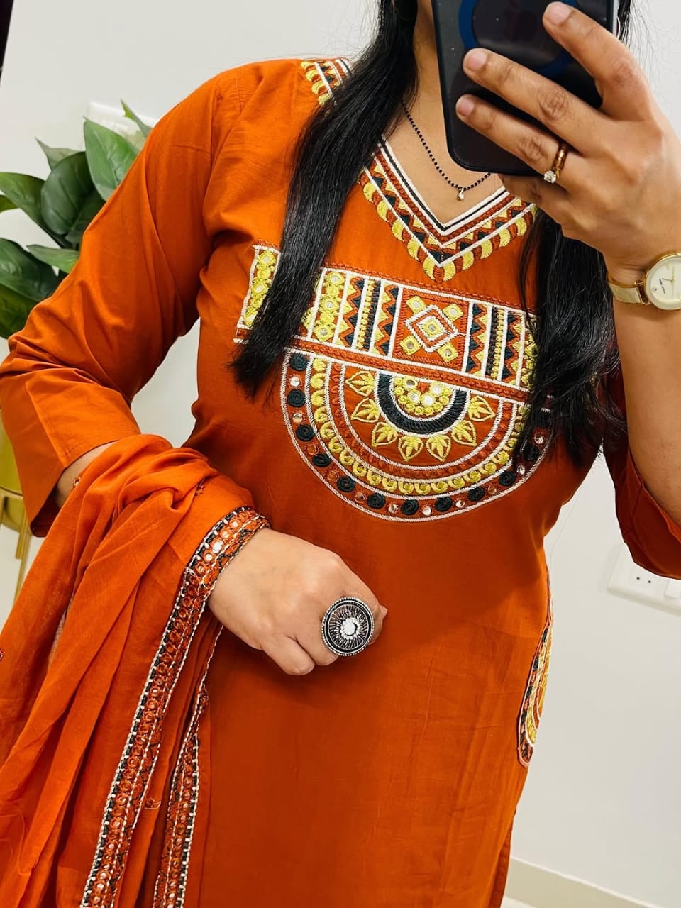 Rust-colored cotton kurta, pant, and dupatta set with embroidery work