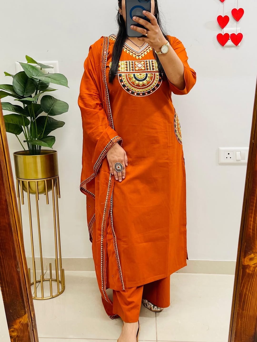 Rust-colored cotton kurta, pant, and dupatta set with embroidery work