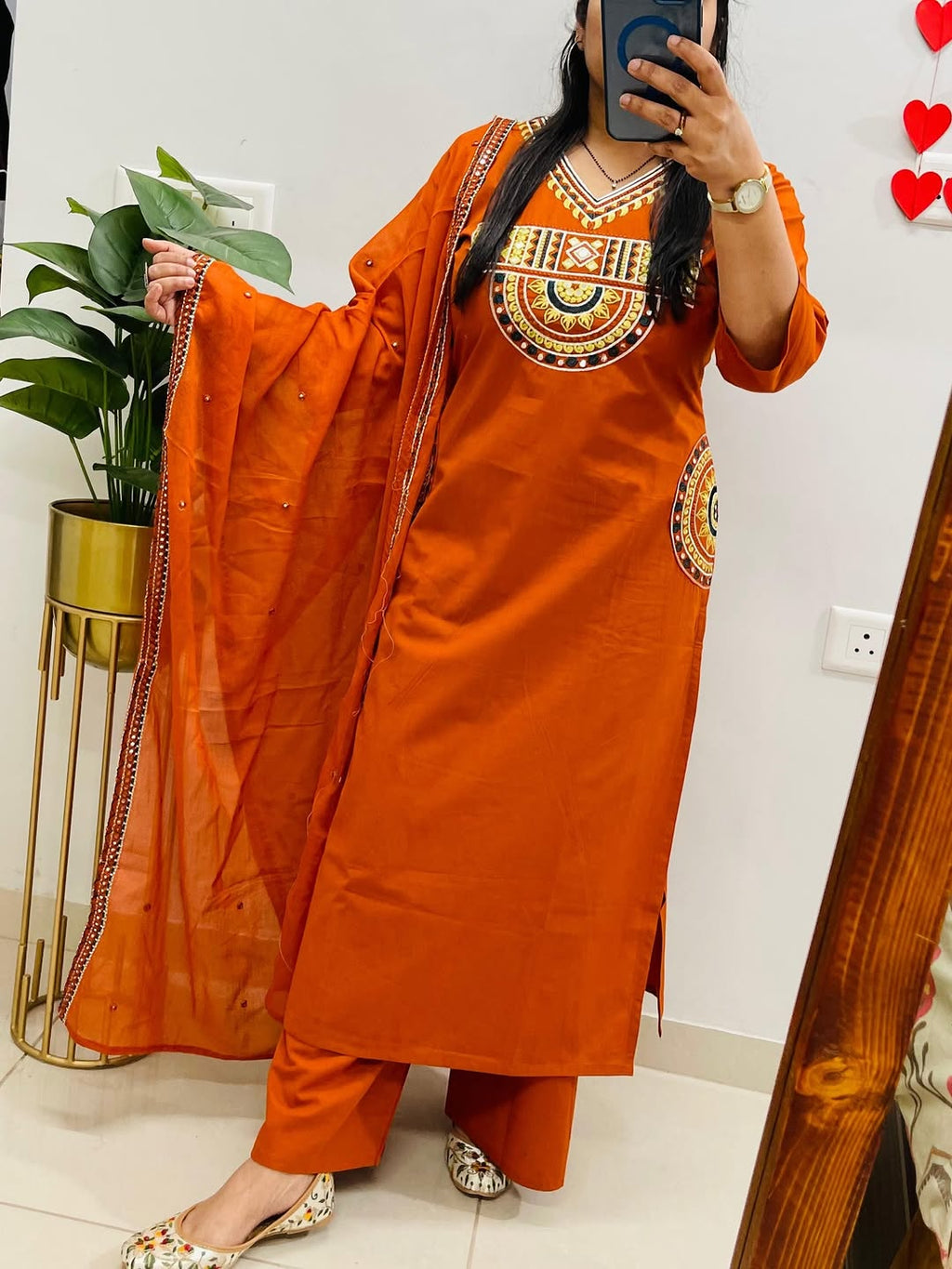 Rust-colored cotton kurta, pant, and dupatta set with embroidery work